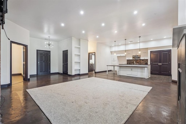 2429 NW 176th St, Edmond, OK 73012 - living room featuring a chandelier, finished concrete floors, and recessed lighting