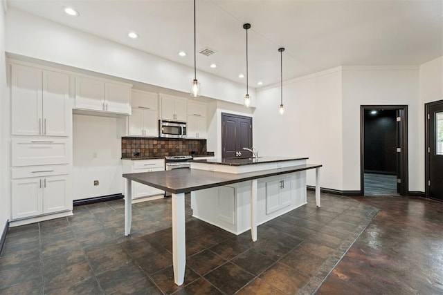 2429 NW 176th St, Edmond, OK 73012 - kitchen featuring appliances with stainless steel finishes, dark countertops, decorative backsplash, white cabinets, and pendant lighting