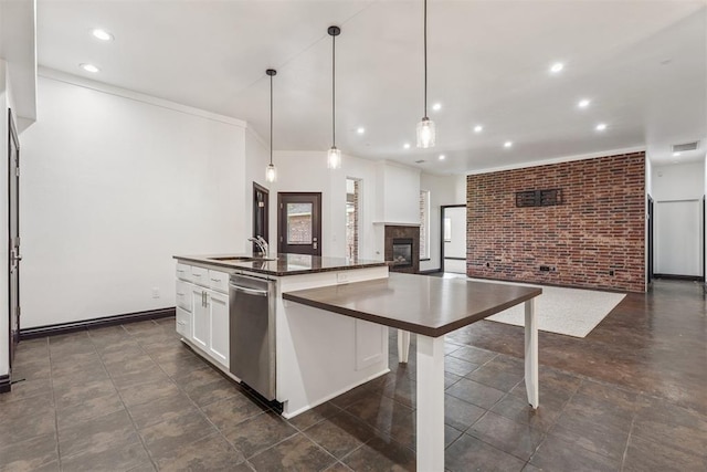 2429 NW 176th St, Edmond, OK 73012 - kitchen featuring stainless steel dishwasher, dark countertops, brick wall, recessed lighting, and open floor plan