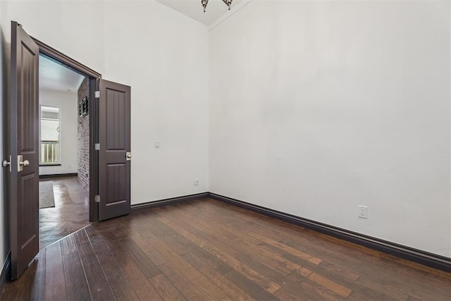 2429 NW 176th St, Edmond, OK 73012 - empty room featuring dark wood-style flooring and a towering ceiling