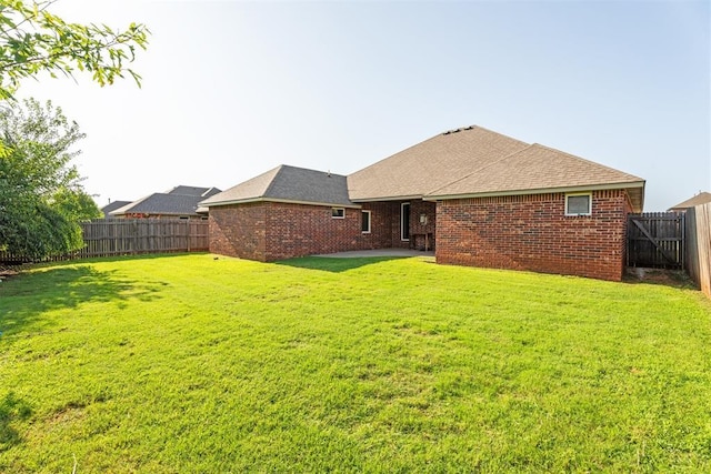 2429 NW 176th St, Edmond, OK 73012 - back of property with a fenced backyard, a patio area, and brick siding