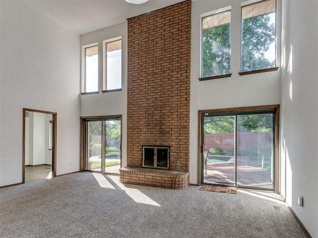 9220 Sutton Pl, Oklahoma City, OK 73132 - unfurnished living room with a towering ceiling, carpet floors, and a brick fireplace