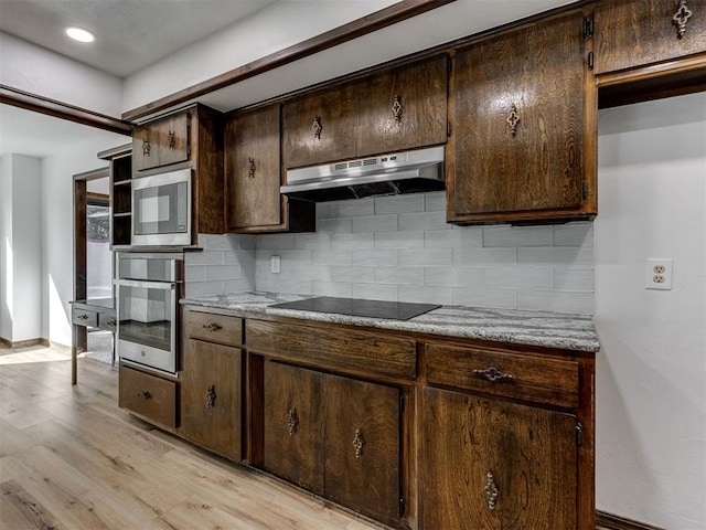 9220 Sutton Pl, Oklahoma City, OK 73132 - kitchen with appliances with stainless steel finishes, under cabinet range hood, backsplash, dark brown cabinets, and recessed lighting