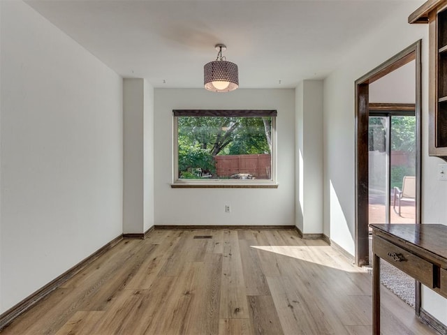 9220 Sutton Pl, Oklahoma City, OK 73132 - unfurnished dining area with light wood-style flooring and healthy amount of natural light