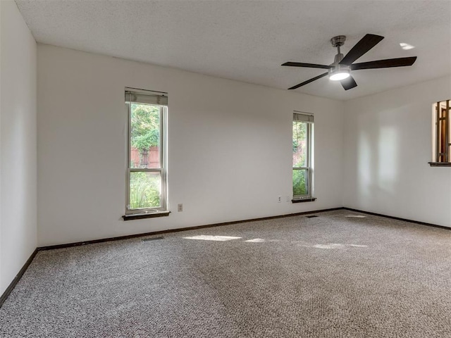 9220 Sutton Pl, Oklahoma City, OK 73132 - empty room featuring carpet flooring, ceiling fan, and a textured ceiling