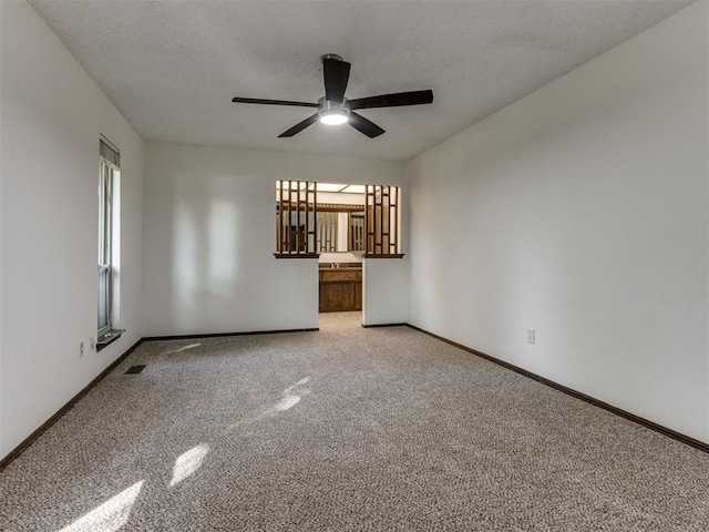 9220 Sutton Pl, Oklahoma City, OK 73132 - unfurnished room with a ceiling fan, carpet, and a textured ceiling