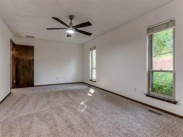 9220 Sutton Pl, Oklahoma City, OK 73132 - carpeted empty room featuring ceiling fan and a textured ceiling