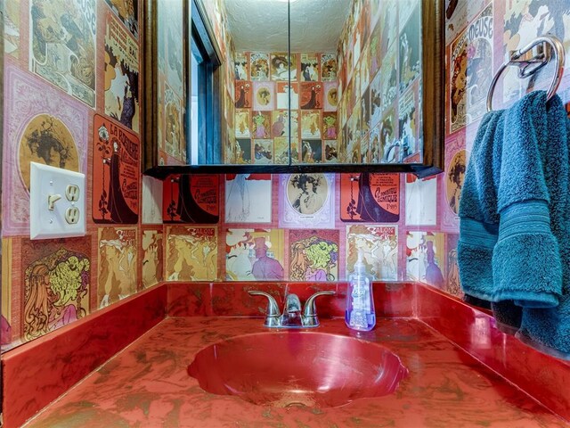 9220 Sutton Pl, Oklahoma City, OK 73132 - bathroom with wallpapered walls, a textured ceiling, and vanity