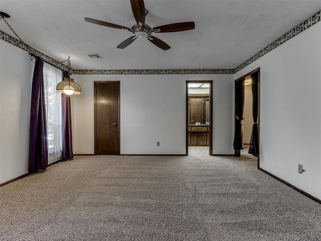 9220 Sutton Pl, Oklahoma City, OK 73132 - empty room featuring carpet flooring, a ceiling fan, and a textured ceiling