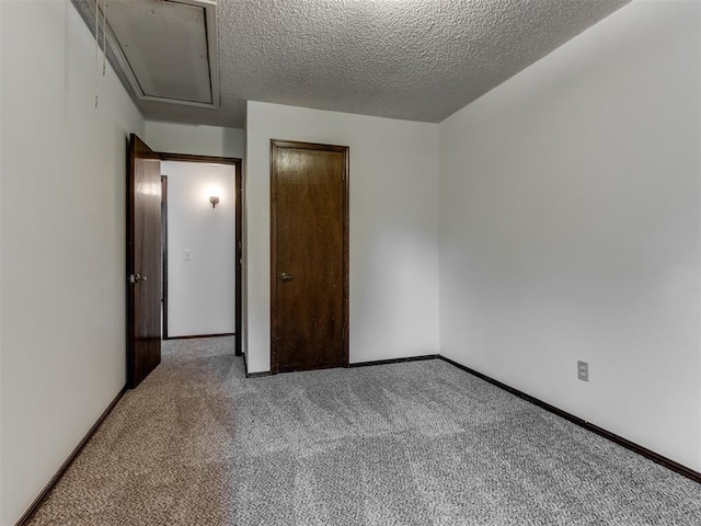 9220 Sutton Pl, Oklahoma City, OK 73132 - unfurnished bedroom featuring carpet floors, attic access, a textured ceiling, and a closet