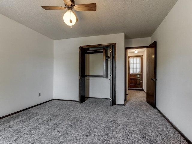 9220 Sutton Pl, Oklahoma City, OK 73132 - unfurnished bedroom featuring carpet flooring, a textured ceiling, and a ceiling fan