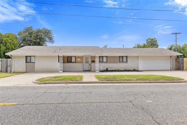 4101 NW 51st St, Oklahoma City, OK 73112 - ranch-style house featuring concrete driveway, a garage, and brick siding
