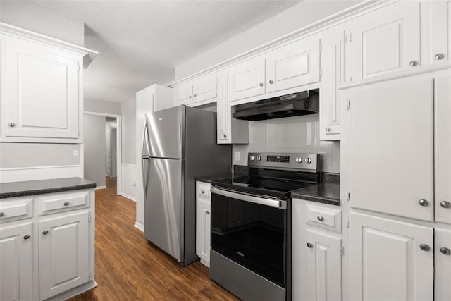 4101 NW 51st St, Oklahoma City, OK 73112 - kitchen featuring appliances with stainless steel finishes, under cabinet range hood, dark countertops, dark wood-style floors, and white cabinetry