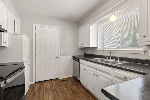 4101 NW 51st St, Oklahoma City, OK 73112 - kitchen featuring dark countertops, appliances with stainless steel finishes, white cabinetry, and dark wood-style flooring
