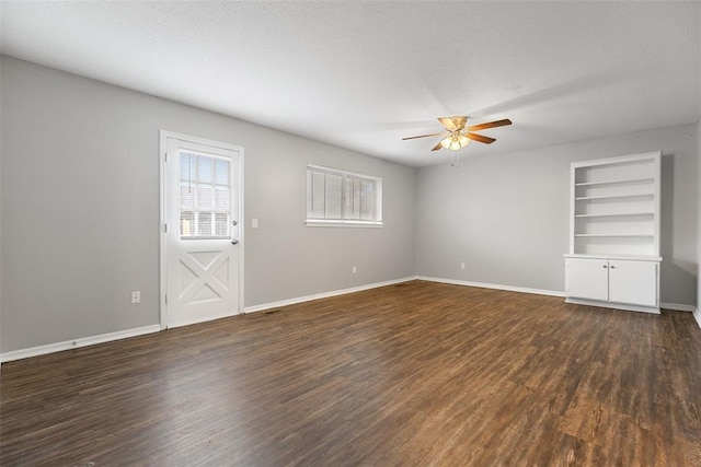 4101 NW 51st St, Oklahoma City, OK 73112 - unfurnished living room with a ceiling fan, dark wood-style flooring, and built in shelves