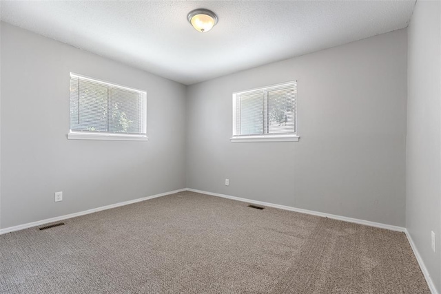 4101 NW 51st St, Oklahoma City, OK 73112 - spare room featuring carpet floors and baseboards