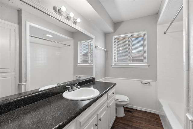 4101 NW 51st St, Oklahoma City, OK 73112 - full bath featuring vanity, wood finished floors, and shower / washtub combination