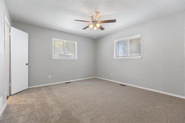 4101 NW 51st St, Oklahoma City, OK 73112 - unfurnished room featuring light carpet, a ceiling fan, and a textured ceiling