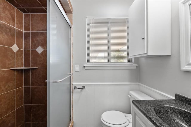 4101 NW 51st St, Oklahoma City, OK 73112 - full bathroom featuring a stall shower, vanity, and a wainscoted wall
