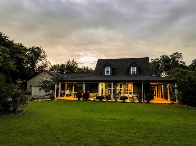1301 E Rock Creek Rd, Tuttle, OK 73089 - back of house at dusk with a porch and a yard