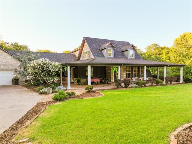 1301 E Rock Creek Rd, Tuttle, OK 73089 - view of front of property featuring covered porch, a front lawn, driveway, roof with shingles, and a garage