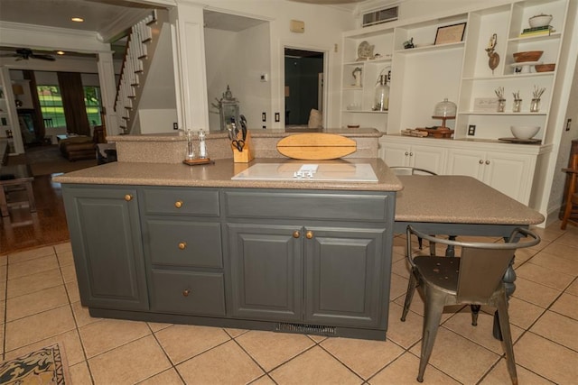 1301 E Rock Creek Rd, Tuttle, OK 73089 - kitchen featuring gray cabinets, open shelves, light tile patterned floors, ornamental molding, and a ceiling fan