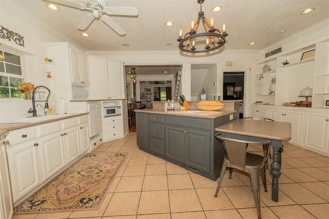1301 E Rock Creek Rd, Tuttle, OK 73089 - kitchen featuring gray cabinetry, light tile patterned floors, white cabinets, crown molding, and recessed lighting