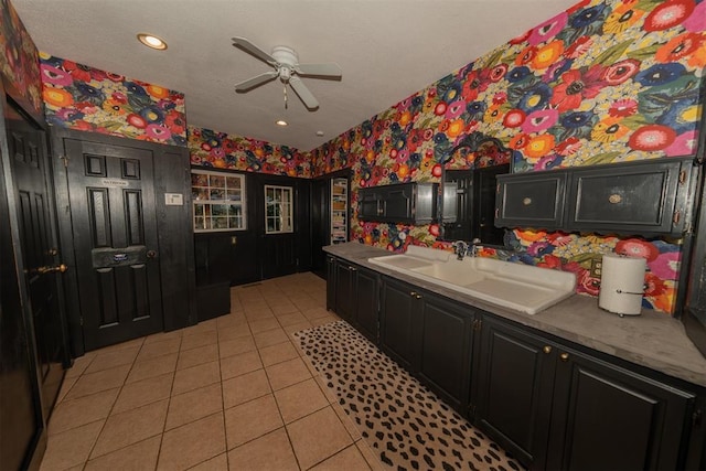 1301 E Rock Creek Rd, Tuttle, OK 73089 - kitchen with wallpapered walls, dark cabinets, light tile patterned flooring, a ceiling fan, and recessed lighting