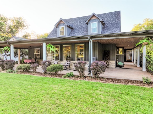 1301 E Rock Creek Rd, Tuttle, OK 73089 - back of property featuring a porch, a yard, board and batten siding, and roof with shingles