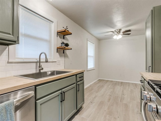 2753 SW 46th Pl, Oklahoma City, OK 73119 - kitchen featuring appliances with stainless steel finishes, tasteful backsplash, light wood finished floors, ceiling fan, and butcher block countertops