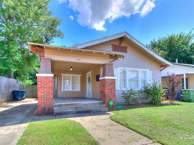 1122 NW 42nd St, Oklahoma City, OK 73118 - view of front of home with covered porch, driveway, and brick siding