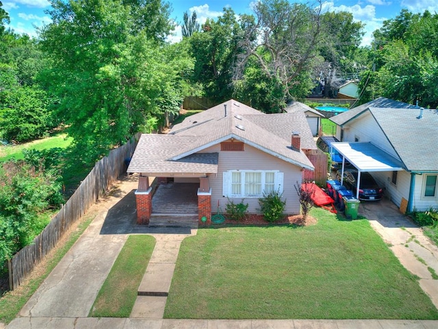 1122 NW 42nd St, Oklahoma City, OK 73118 - bungalow-style home with concrete driveway, a carport, roof with shingles, and a porch