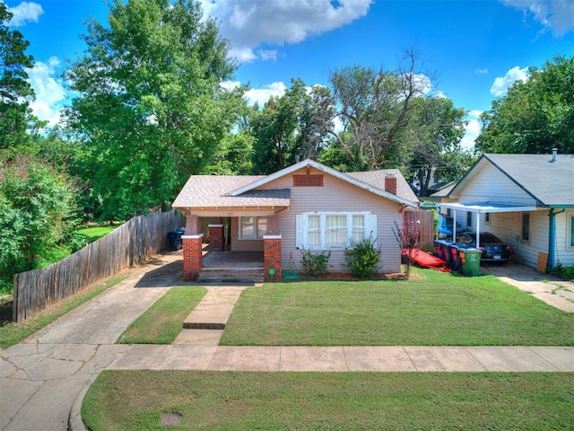 1122 NW 42nd St, Oklahoma City, OK 73118 - bungalow-style house featuring a porch, driveway, and a carport