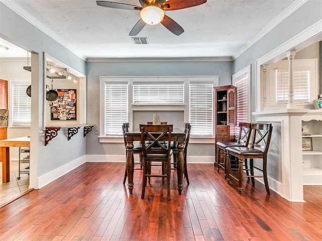 1122 NW 42nd St, Oklahoma City, OK 73118 - dining room featuring ceiling fan, wood-type flooring, and crown molding