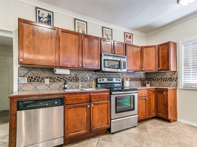 1122 NW 42nd St, Oklahoma City, OK 73118 - kitchen featuring appliances with stainless steel finishes, crown molding, backsplash, light tile patterned flooring, and light countertops