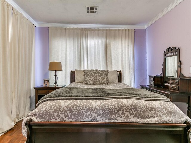 1122 NW 42nd St, Oklahoma City, OK 73118 - bedroom featuring ornamental molding and wood finished floors