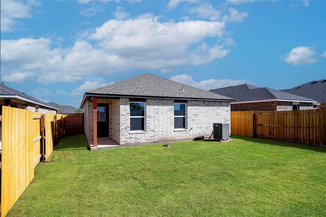 12729 Carrara Ln, Yukon, OK 73099 - rear view of house featuring brick siding, a fenced backyard, and a shingled roof