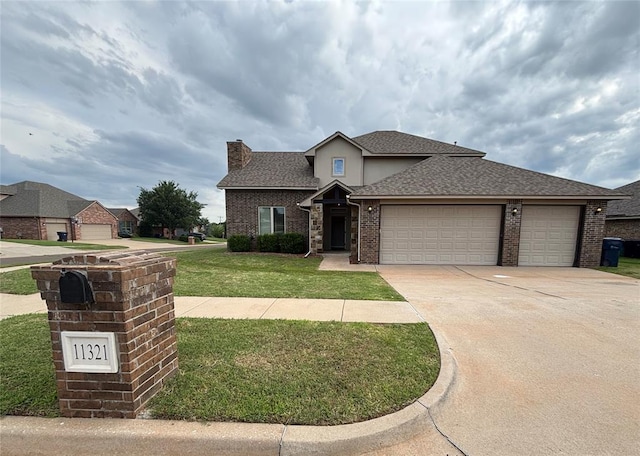 11321 NW 102nd St, Yukon, OK 73099 - view of front facade with a front yard, a chimney, a garage, concrete driveway, and roof with shingles