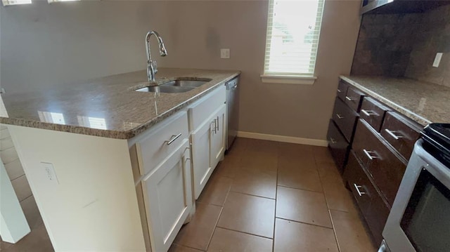 11321 NW 102nd St, Yukon, OK 73099 - kitchen with stainless steel dishwasher, light stone counters, white cabinets, and dark brown cabinetry