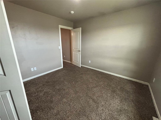 11321 NW 102nd St, Yukon, OK 73099 - spare room featuring baseboards and dark colored carpet