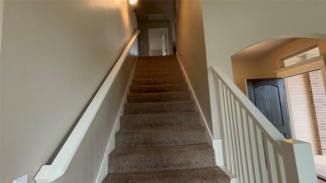 11321 NW 102nd St, Yukon, OK 73099 - staircase featuring arched walkways and carpet floors