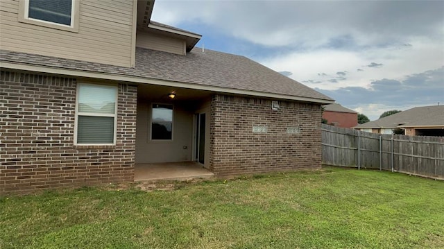 11321 NW 102nd St, Yukon, OK 73099 - rear view of house featuring brick siding and roof with shingles