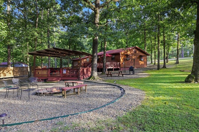 17 Halibut Bay Rd, Broken Bow, OK 74728 - view of yard featuring an outdoor fire pit, a gazebo, a wooden deck, and view of wooded area
