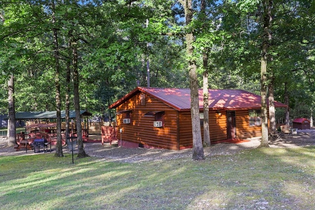 17 Halibut Bay Rd, Broken Bow, OK 74728 - view of side of home featuring faux log siding, a lawn, and a metal roof