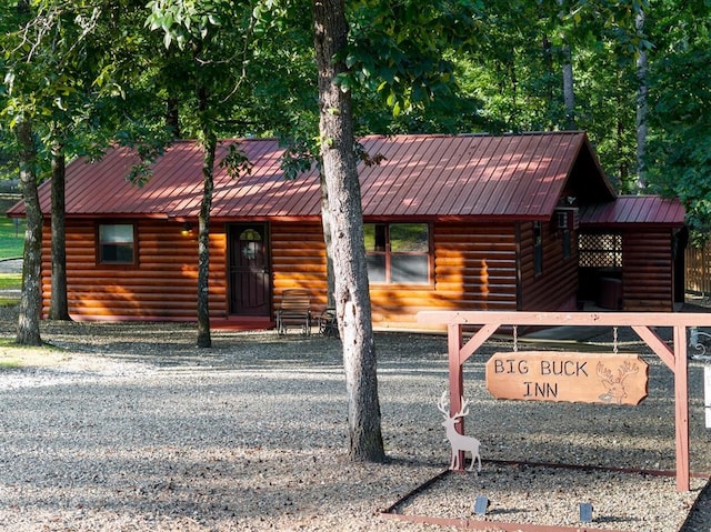 17 Halibut Bay Rd, Broken Bow, OK 74728 - view of front facade with log veneer siding and a metal roof