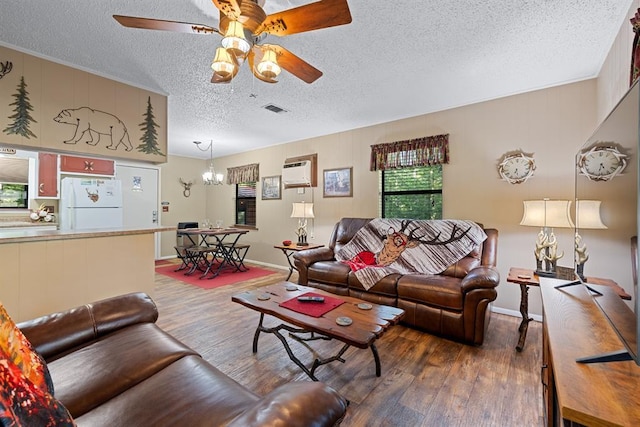 17 Halibut Bay Rd, Broken Bow, OK 74728 - living room with a textured ceiling, wood finished floors, a ceiling fan, a chandelier, and a wall mounted air conditioner