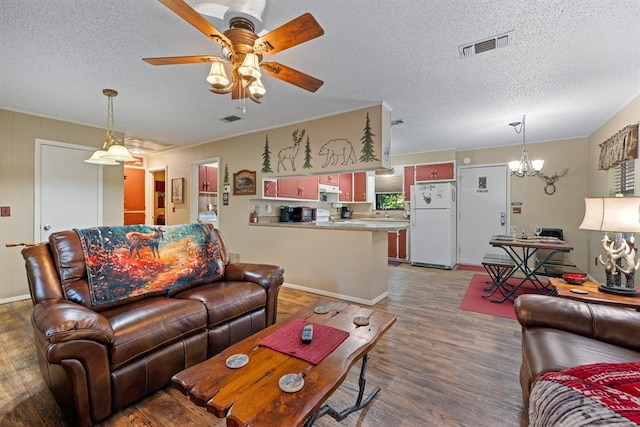 17 Halibut Bay Rd, Broken Bow, OK 74728 - living room featuring a textured ceiling, wood finished floors, ceiling fan, and a chandelier