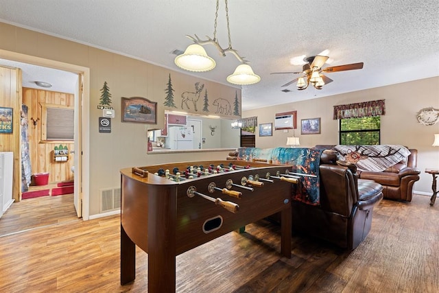 17 Halibut Bay Rd, Broken Bow, OK 74728 - recreation room featuring ceiling fan, wood finished floors, a textured ceiling, and crown molding