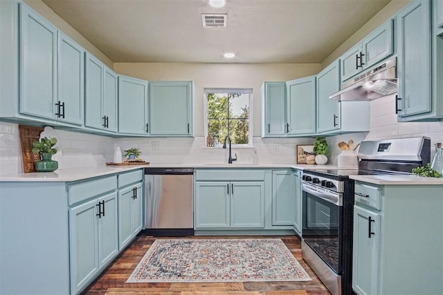 102078 S 3480th Rd, Meeker, OK 74855 - kitchen with appliances with stainless steel finishes, under cabinet range hood, backsplash, and dark wood finished floors