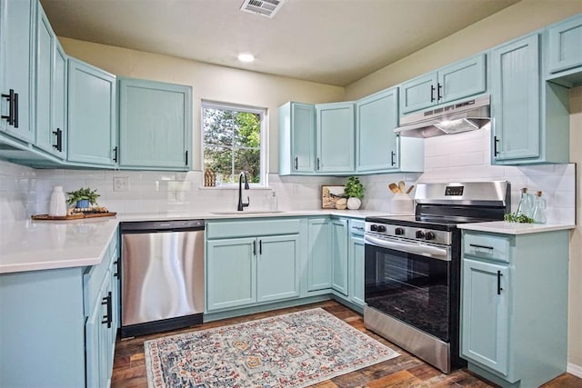 102078 S 3480th Rd, Meeker, OK 74855 - kitchen featuring appliances with stainless steel finishes, under cabinet range hood, blue cabinetry, decorative backsplash, and recessed lighting